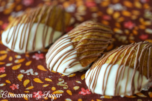 Pumpkin Spiced Madeleines are cake-like cookies dipped in white chocolate & drizzled with chocolate. Elegant enough for guests, the kids will love them too.