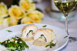 Stuffed Chicken Breast with Lemon-Tarragon Sauce uses crispy pancetta, mild, nutty Fontina cheese and vibrant baby spinach for a beautiful, delicious meal. Recipe shared with permission granted by Barbara Ross, author of FOGGED INN. 