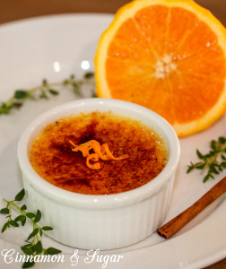 This Orange Cinnamon Crème Brûlée recipe steeps cinnamon, thyme and orange peel in a custard base to add a complex subtlety to this decadently creamy dessert that is crowned with a crunchy bittersweet layer of yumminess. Recipe shared with permission granted by Leslie Budewitz, author of GUILTY AS CINNAMON.