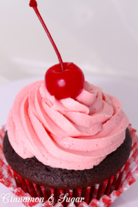 Rich chocolate cola cupcakes with the sweetness of cherries, are topped with super creamy cherry cola buttercream frosting. One bite will make you feel like you're sitting in an old-fashioned soda fountain! Recipe shared with permission granted by Jenn McKinlay, author of VANILLA BEANED.