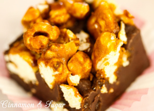 Popcorn Fudge combines amazing crunchy caramel corn on top of a thick layer of fool-proof creamy, rich fudge which boasts a hint of spiciness. Recipe shared with permission granted by Kristi Abbott, author of KERNEL OF TRUTH.