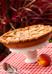 Juicy sweet peaches are laced with brown sugar, cinnamon, and nutmeg then topped with a flaky lattice crust to make the BEST peach pie ever! 