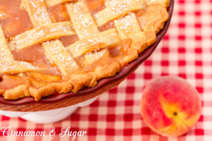 Juicy sweet peaches are laced with brown sugar, cinnamon, and nutmeg then topped with a flaky lattice crust to make the BEST peach pie ever! 