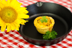 Barbecue Muffins are flaky homemade biscuits formed into hand-held muffins and stuffed with tangy barbecue meat then topped with flavorful cheddar cheese.