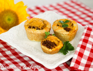 Barbecue Muffins are flaky homemade biscuits formed into hand-held muffins and stuffed with tangy barbecue meat then topped with flavorful cheddar cheese.