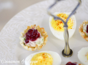 Mini Cranberry Crab Cakes are perfect appetizers for holidays with creamy flavorful crab filling in crunchy tart shells & topped with sweet cranberry sauce.