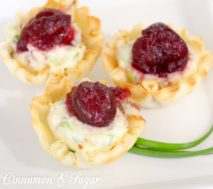 Mini Cranberry Crab Cakes are perfect appetizers for holidays with creamy flavorful crab filling in crunchy tart shells & topped with sweet cranberry sauce.