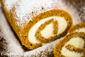 Pumpkin Roll Cake combines a thin layer of spiced pumpkin cake with creamy, tangy cream cheese rolled inside. Delicious and picture perfect presentation!