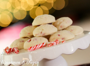 Candy Cane Snowball Cookies are buttery cookies blended with crunchy festive peppermint candy canes. Perfect for holiday dessert tables and gift giving!