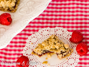 Oatmeal Raspberry Crumble Bars mix up quickly with a hearty, tasty crust and topping sandwiching sweet-tart raspberry filling providing a satisfying treat. 