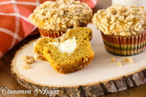 Pumpkin Cream Cheese-filled Muffins with Streusel Topping are lightly spiced muffins with a tangy, creamy center, while streusel provides crunchy contrast.