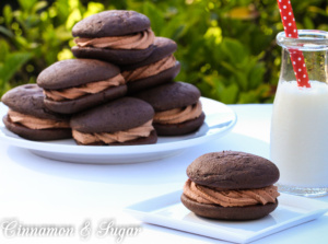 Chocolate Whoopie Pies w/ Nutella Buttercream Filling are part cookie, part mini cakes. Moist cake sandwiches Nutella Buttercream flavored with Frangelico!