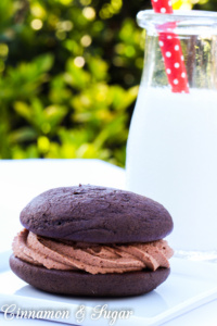 Chocolate Whoopie Pies w/ Nutella Buttercream Filling are part cookie, part mini cakes. Moist cake sandwiches Nutella Buttercream flavored with Frangelico!