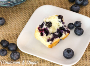 Mrs. Hudson's Tea Room Blueberry Muffins are tender vanilla cakes filled with juicy blueberries and topped with nutmeg-scented sugar for a crunchy contrast.