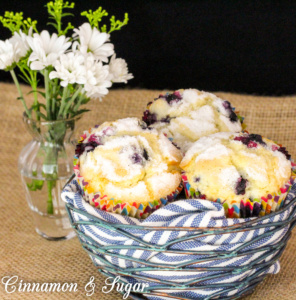 Mrs. Hudson's Tea Room Blueberry Muffins are tender vanilla cakes filled with juicy blueberries and topped with nutmeg-scented sugar for a crunchy contrast.