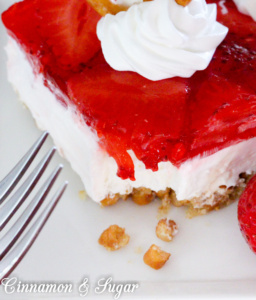 Salty, crunchy pretzel crust is topped with tangy and creamy cream cheese then crowned with sweet strawberry jello and juicy ripe fresh strawberries to create Pittsburgh Pretzel Salad.