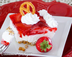 Salty, crunchy pretzel crust is topped with tangy and creamy cream cheese then crowned with sweet strawberry jello and juicy ripe fresh strawberries to create Pittsburgh Pretzel Salad.