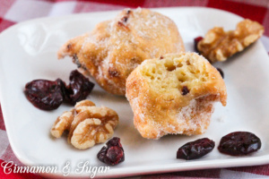 Cranberry-Orange-Walnut Fritters are small fried balls of yumminess! Studded with bits of tart cranberries, crunchy walnuts and plenty of orange zest, these will become a family favorite for special breakfasts or snacks. 