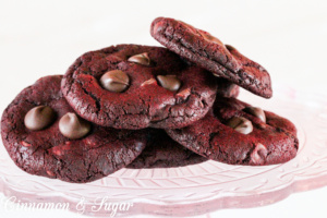 Red Velvet Crunchies has a cookie base of chocolate red velvet and a generous amount of chocolate chips added to the dough. Additional chocolate chips are pressed into the tops as soon as the cookies are done baking. These warm, gooey chocolate cookies will be a huge hit when served with an ice cold glass of milk.