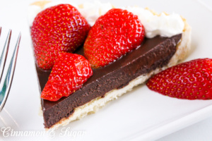 A flaky, buttery crust provides the base for a decadently, rich Chocolate Truffle Tart that is garnished with juicy, red strawberries and sweetened whipped cream. Chocolate and strawberries are the perfect combination to impress your family and friends! 