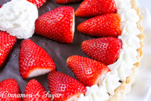 A flaky, buttery crust provides the base for a decadently, rich Chocolate Truffle Tart that is garnished with juicy, red strawberries and sweetened whipped cream. Chocolate and strawberries are the perfect combination to impress your family and friends! 