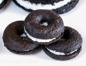 Black-and-Whites Baked Donuts are rich, super chocolately donuts with a creamy filling, reminiscent of everyone's favorite chocolate sandwich cookies. 