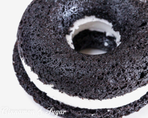 Black-and-Whites Baked Donuts are rich, super chocolately donuts with a creamy filling, reminiscent of everyone's favorite chocolate sandwich cookies. 