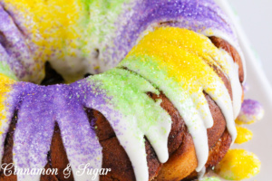 Canned cinnamon rolls layered into a bundt pan and then slathered with a brown sugar & cinnamon mixture before baking creates Easy-Peasy King (Bundt) Cake, a Mardi Gras tradition!