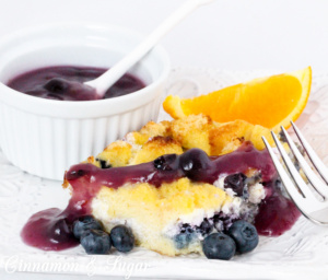 Rich & satisfying with eggs, dairy, and blueberries and topped with a warm blueberry sauce, Baked Blueberry French Toast is a delicious make-ahead dish! 