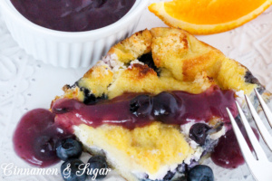 Rich & satisfying with eggs, dairy, and blueberries and topped with a warm blueberry sauce, Baked Blueberry French Toast is a delicious make-ahead dish! 