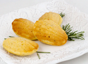 Rosemary Cornmeal Madeleines are an elegant way to serve cornbread. Delicious warmed up with butter, this cornbread features a hint of rosemary and Asiago. Recipe shared with permission granted by Amy Patricia Meade, author of Cookin' the Books.