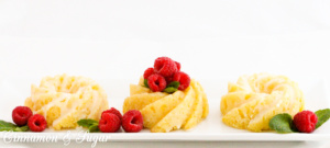 Lemon Tea Cakes have layers of bright, sunny flavor thanks to plenty of lemon juice and zest used in the sweet quick bread batter, glaze, and frosting. Recipe shared with permission granted by Daryl Wood Gerber, author of SIFTING THOUGH CLUES.