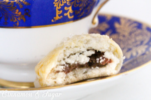 Lucy's Date-Stuffed Cookies have a sweet, cinnamon-y filling that is encased in flaky cookie dough -- like a mini turnover! Recipe shared with permission granted by Tina Kashian, author of ONE FETA IN THE GRAVE.
