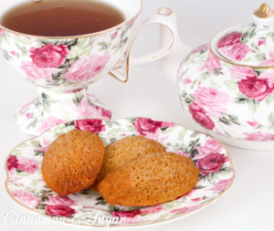 Paleo Earl Grey Madeleines are gluten- & dairy-free cake-like cookies. A subtle hint of Earl Gray tea make these perfect for tea-time or a champagne brunch! Recipe shared from cozy mystery, RESTAURANT WEEKS ARE MURDER by Libby Klein. 