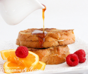 Stuffed French Toast are slices of French bread stuffed with orange zest and cream cheese. Paired with Honey Orange Syrup makes it a perfect breakfast! Recipe shared with permission granted by Kate Carlisle, author of THE BOOK SUPREMACY.