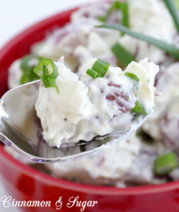 Daisy Carpenter's Secret Potato Salad with Dill combines red potatoes, for texture & color, with creamy, tangy mayo & sour cream. A generous amount of dill and scallions provide fresh flavor. Recipe shared from SOMETHING BORROWED, SOMETHING MEWED by Bethany Blake.