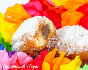 Popular in Hawaii, malasadas are rich with eggs, butter and milk. Deep-fried, then coated with sugar, these pillowy donuts are filled with coconut or chocolate custard. Recipe shared with permission granted by Josi Avari, author of NEST EGG.