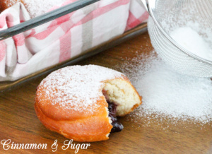 Jelly-filled donuts are yeasty deep-fried treats, stuffed with fruity jam and dusted with confectioner's sugar. Perfect for breakfast and coffee breaks! Recipe shared with permission granted by Ginger Bolton, author of Jealousy Filled Donuts.