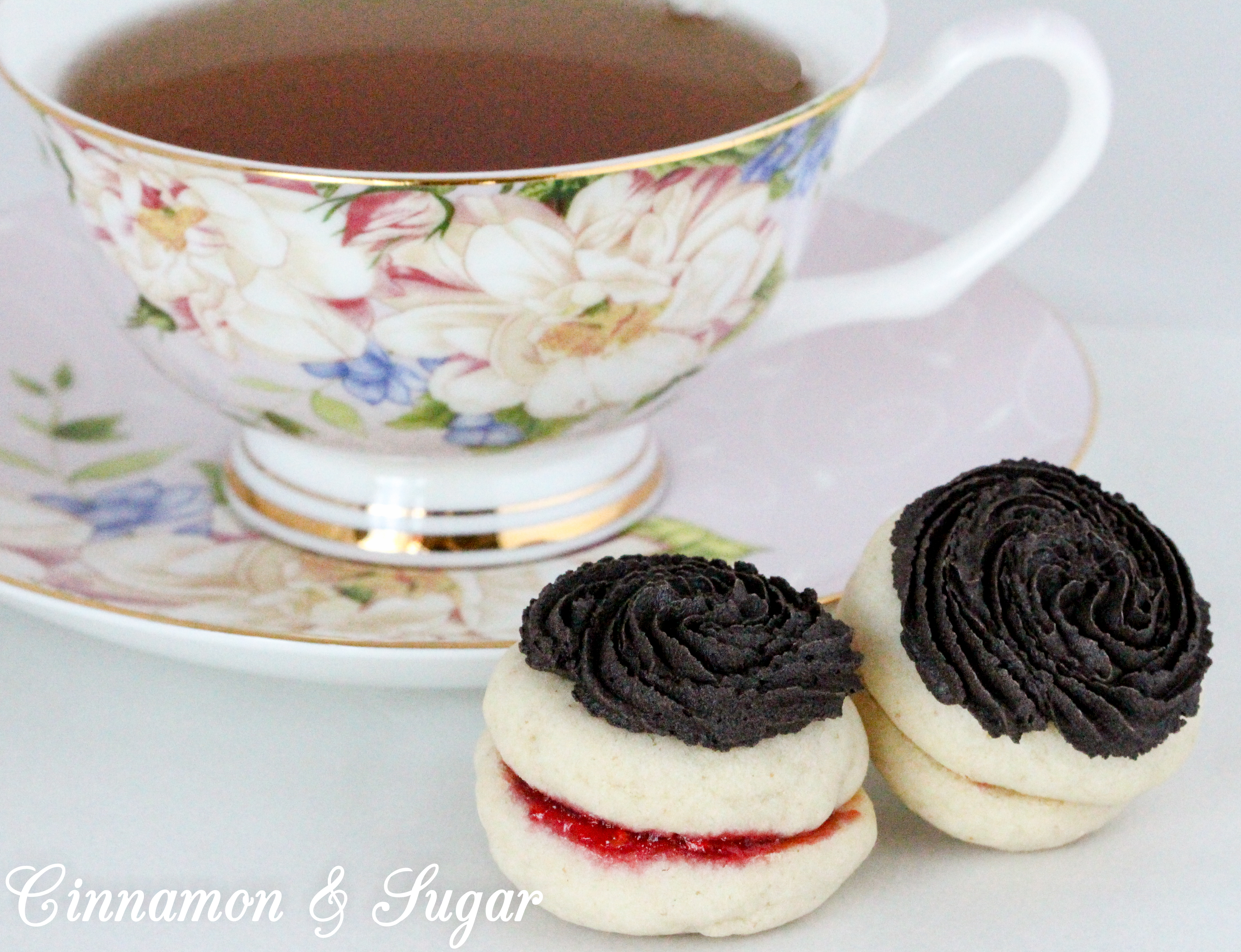 Mom’s Antoinettes are buttery, almond-flavored shortbread-style cookies that are sandwiched around raspberry jam and topped with dark chocolate buttercream. Recipe shared with permission granted by Ellie Alexander, author of A CUP OF HOLIDAY FEAR. 