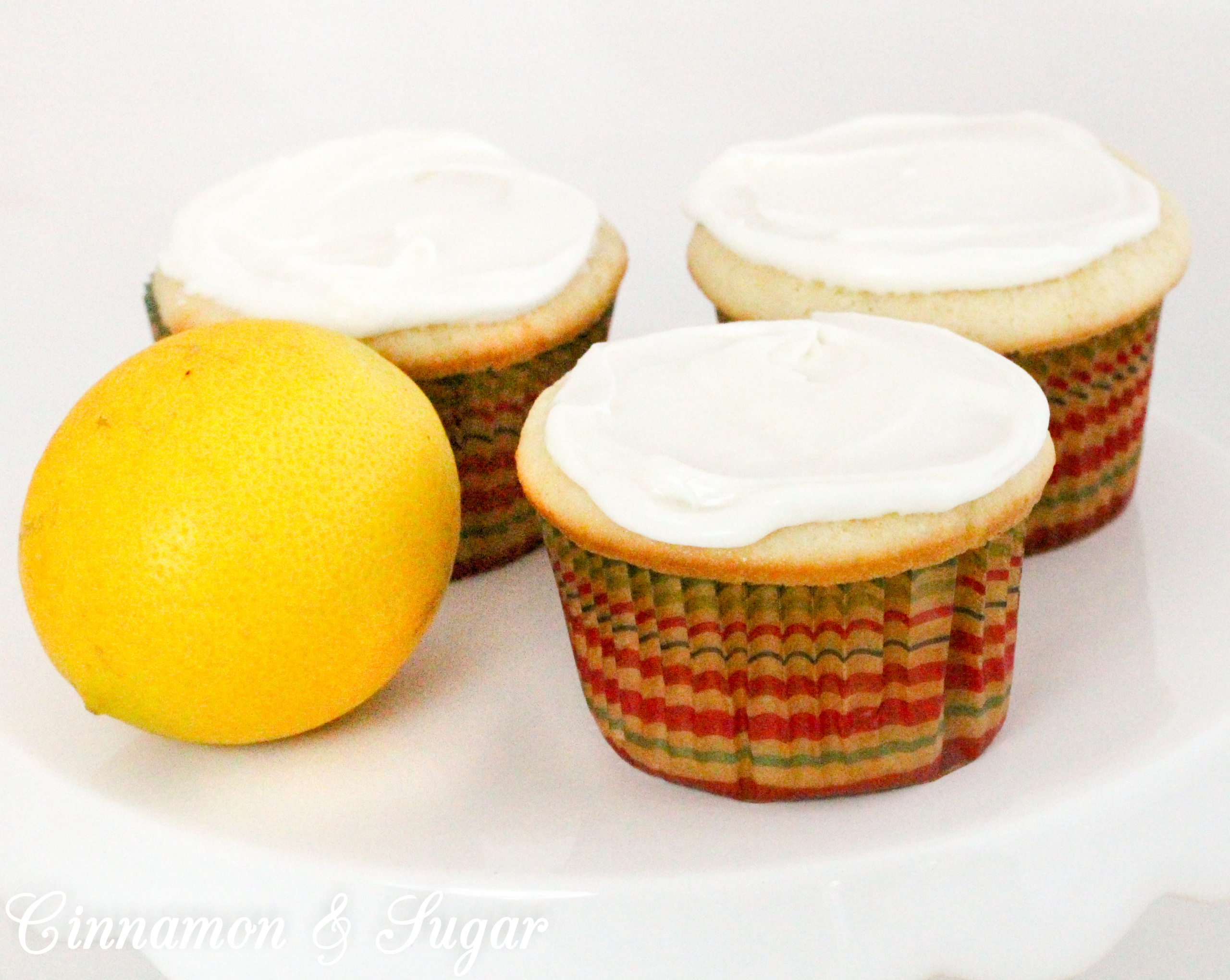 Lemony cream cheese frosting tops little lemon cakes that are super moist thanks to a generous dollop of sour cream. Perfect for afternoon tea or brunch! Recipe shared with permission granted by Maureen Klovers, author of MURDER IN THE MOONSHINE. 
