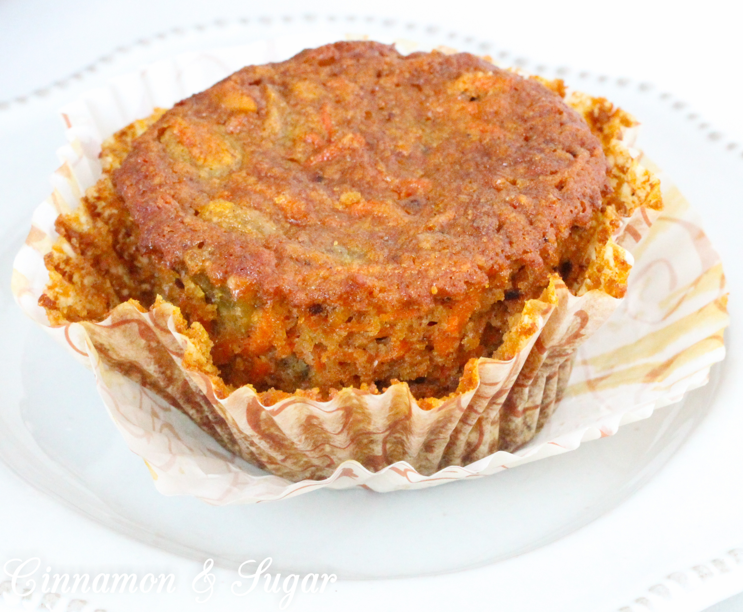 Paleo Carrot Cake Muffins with Rum Raisins are chock-full of flavor and moistness thanks to rum-infused golden raisins, a generous portion of carrots, with warming spices and honey. Recipe shared with permission granted by Libby Klein, author of THEATER NIGHTS ARE MURDER. 