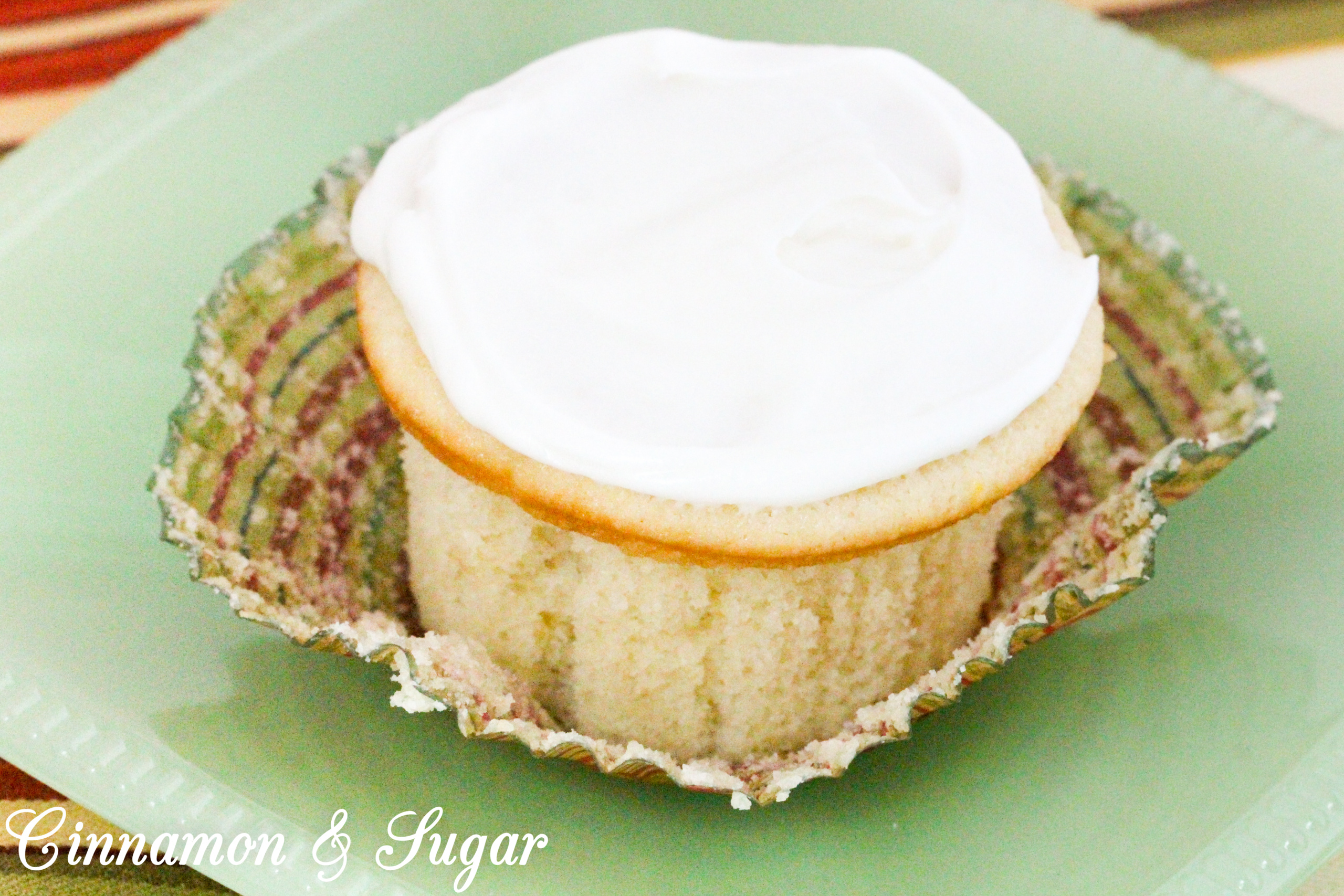 Lemony cream cheese frosting tops little lemon cakes that are super moist thanks to a generous dollop of sour cream. Perfect for afternoon tea or brunch! Recipe shared with permission granted by Maureen Klovers, author of MURDER IN THE MOONSHINE. 