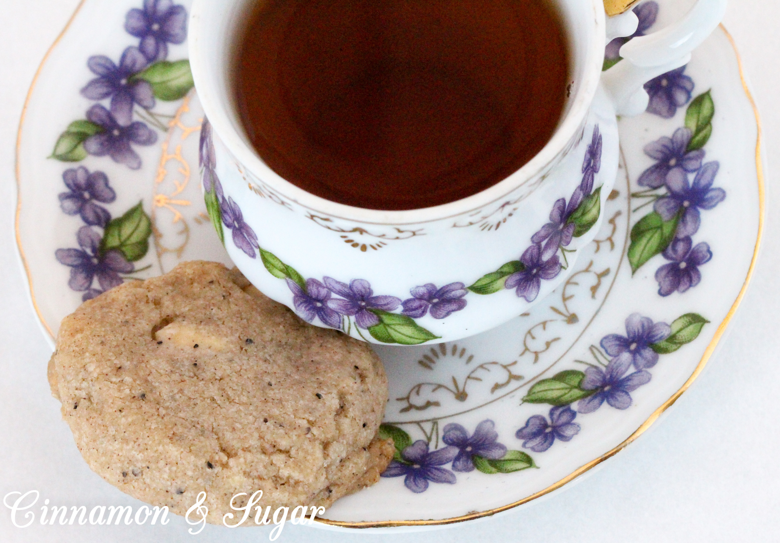 Ginger-Cardamom Tea Cookies are a shortbread-style cookies infused with English Breakfast Tea! Warming spices provide plenty of flavor while white chocolate chips give a burst of creamy sweetness to each bite. Recipe shared with permission granted by Laura Childs, author of LAVENDER BLUE MURDER. 