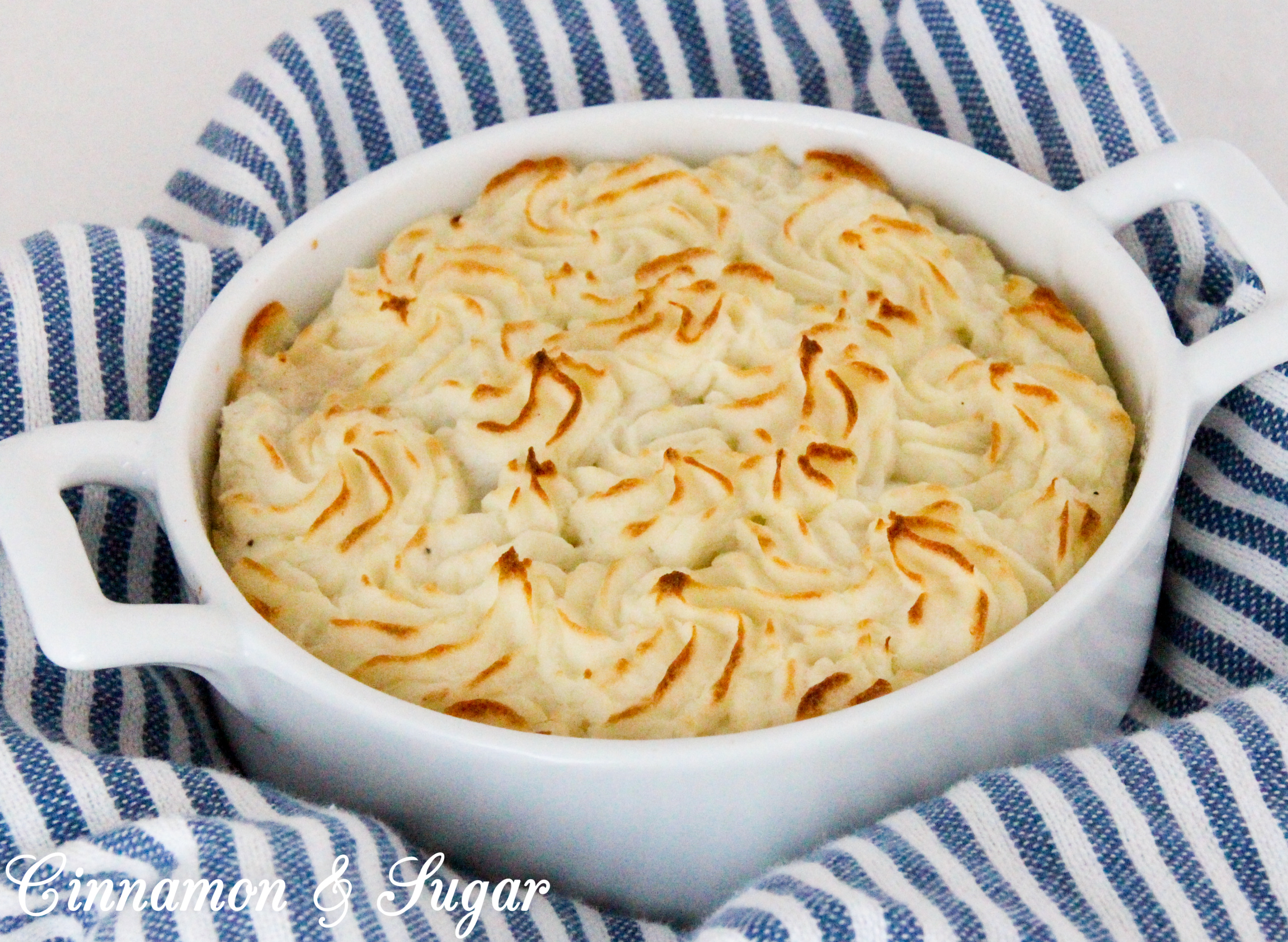 Shepherd’s Pie is comfort food at its purest! Rich browned beef and some veggies are smothered with creamy mashed potatoes and then baked to create a hearty, warming meal. Recipe shared with permission granted by Lynn Cahoon, author of DEEP FRIED REVENGE.