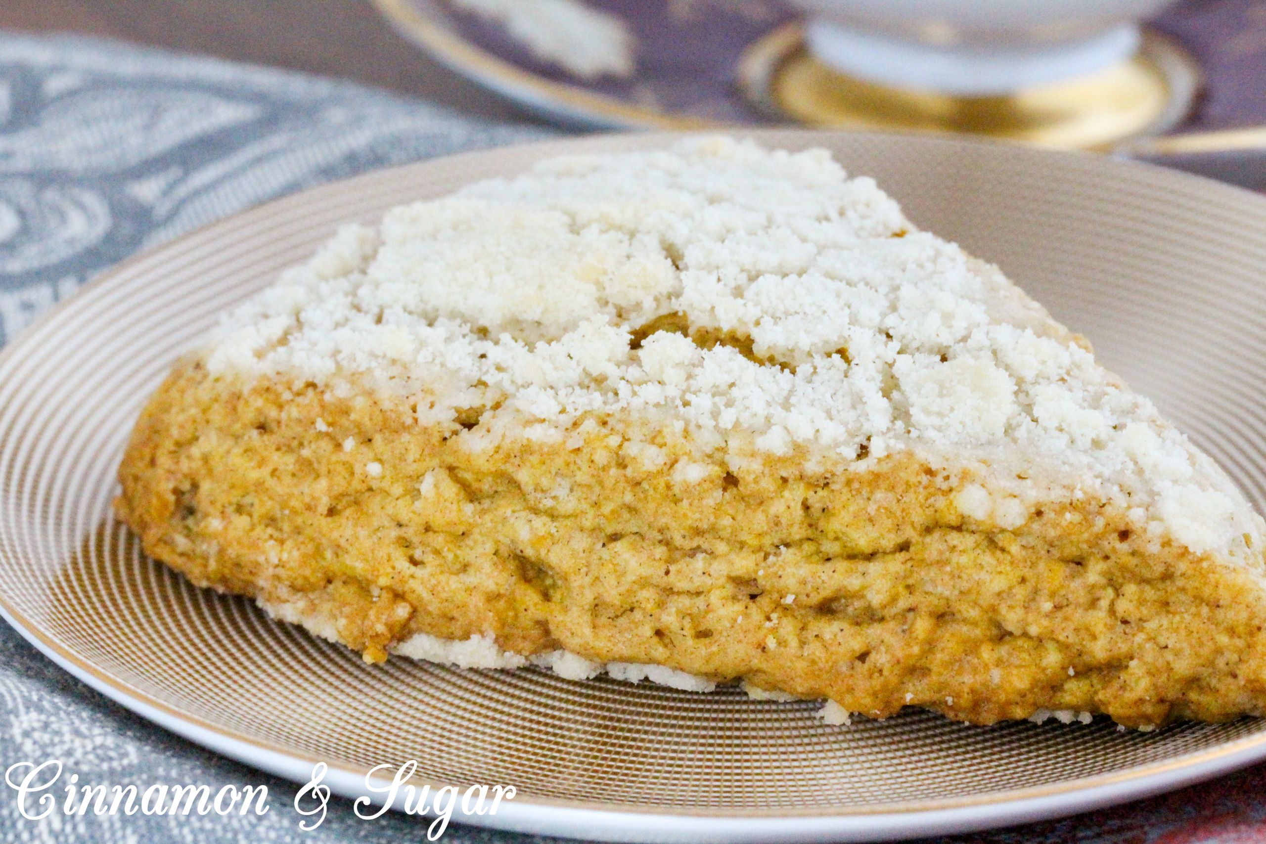 Sweet streusel complements the cinnamon in these Maple-Pumpkin Scones without being overly crumbly. Mild pumpkin brings color and a moist texture to these tea time treats. Recipe shared with permission granted by Kate Carlisle, author of THE GRIM READER. 