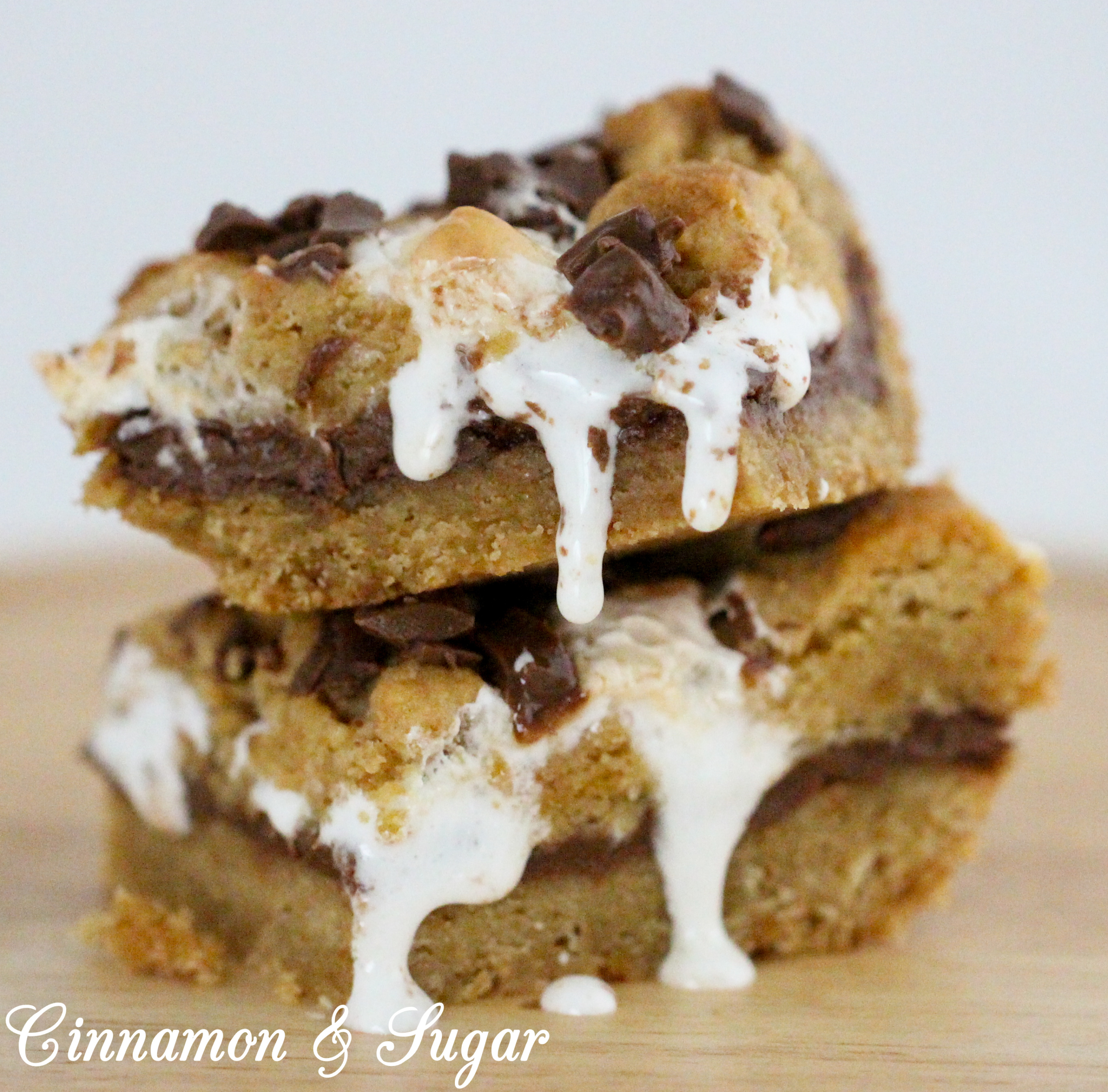 No campfires required! S'mores Cookie Bars have a graham cracker cookie dough base and topping, and a rich layer of iconic chocolate bars with gooey marshmallows. Recipe created by Cinnamon & Sugar for Catherine Bruns, author of KNEE DEEP IN DOUGH.