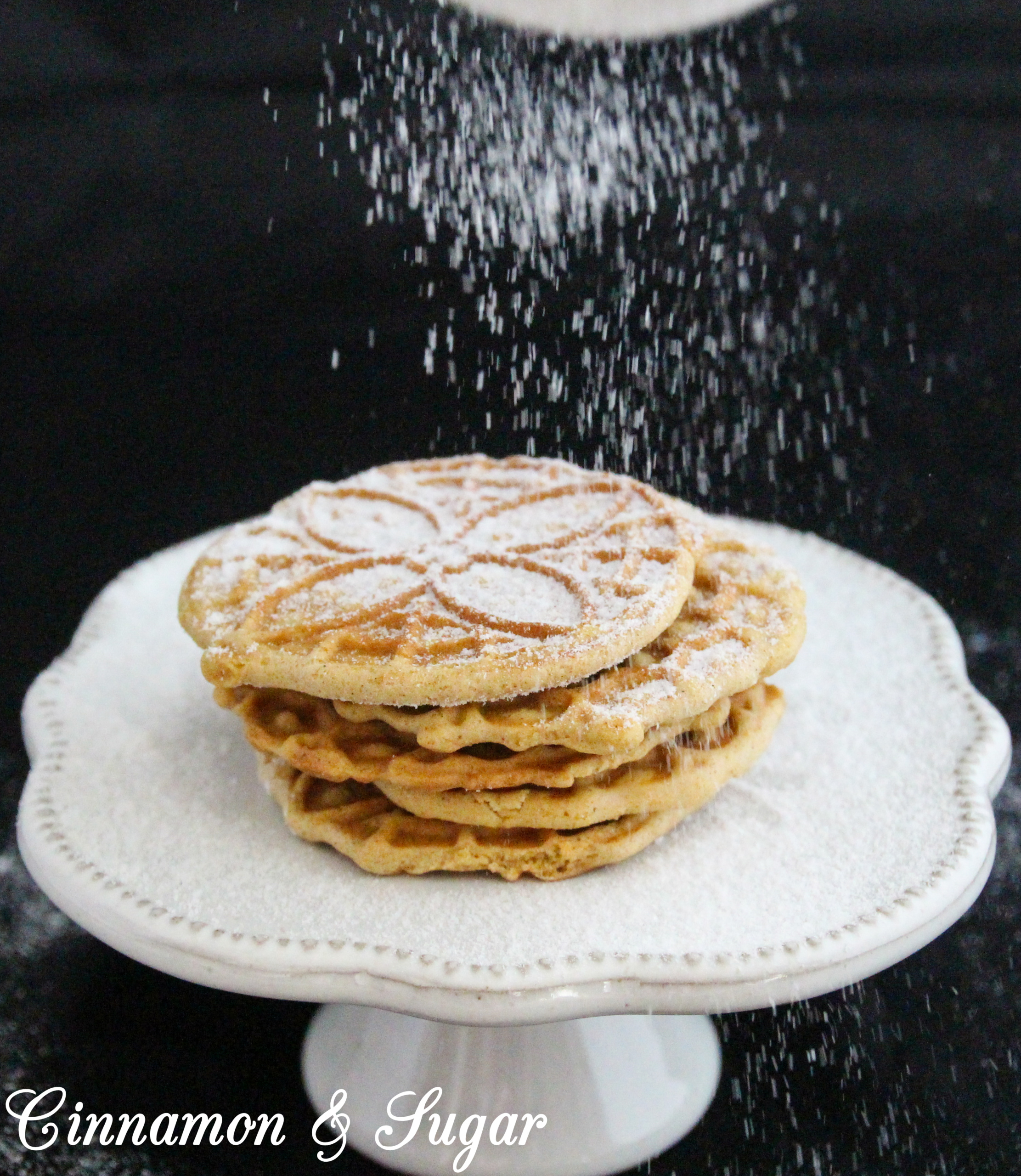 Warming spices and sugary goodness will make your kitchen smell like Christmas when you make these Gingerbread Pizzelles! Recipe created by Cinnamon & Sugar for Catherine Bruns, author of THE ENEMY YOU GNOCCHI.