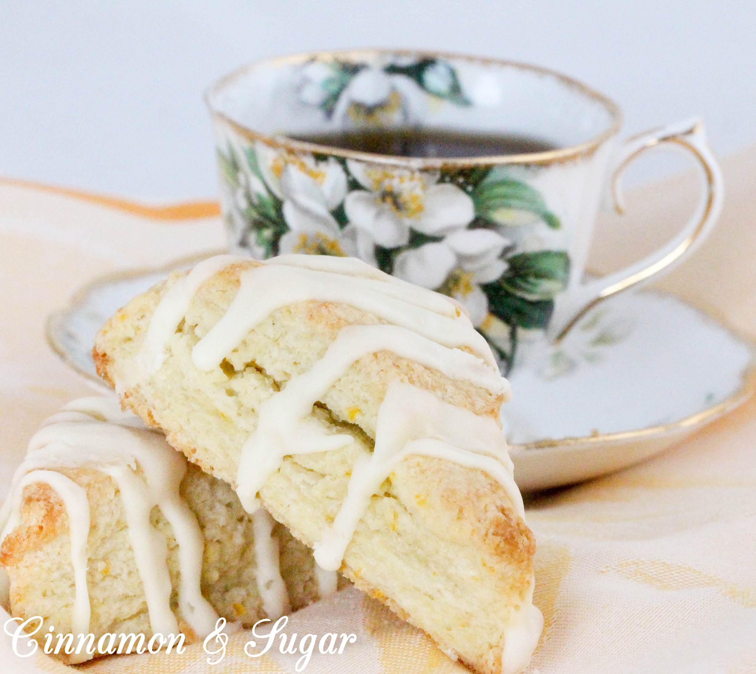 These flaky Orange Scones are easy to mix up and the sweet, orange glaze boosts the wow factor. Scrumptious on their own, a smear of orange marmalade would make them even more delectable! Recipe shared with permission granted by Maddie Day, author of NACHO AVERAGE MURDER. 