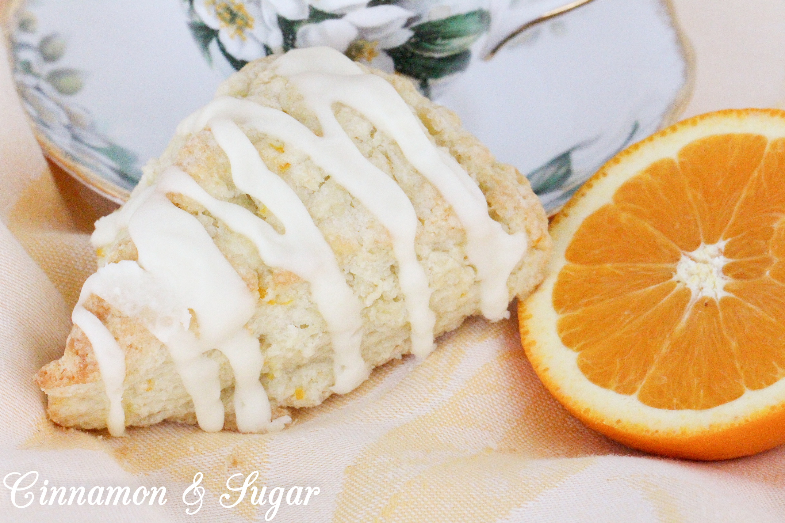 These flaky Orange Scones are easy to mix up and the sweet, orange glaze boosts the wow factor. Scrumptious on their own, a smear of orange marmalade would make them even more delectable! Recipe shared with permission granted by Maddie Day, author of NACHO AVERAGE MURDER. 