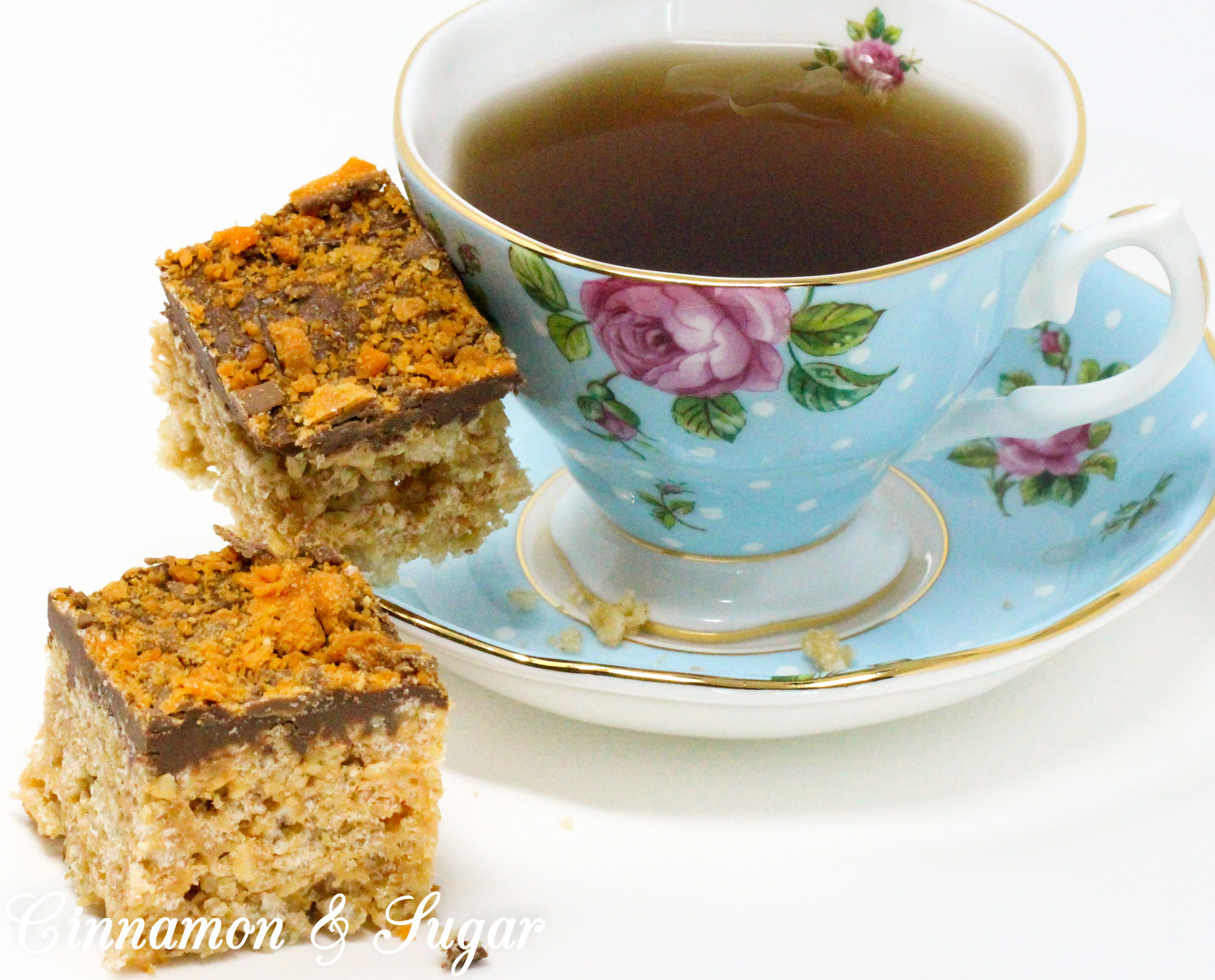 A delicious riff on Rice Krispie Treats, Butterfinger Krispie Bars combines the flavors of the iconic candy bar: chocolate, butterscotch, and peanut butter! Recipe created by Cinnamon & Sugar for Deborah Garner, author of cozy mystery, A FLAIR FOR GOBLINS.